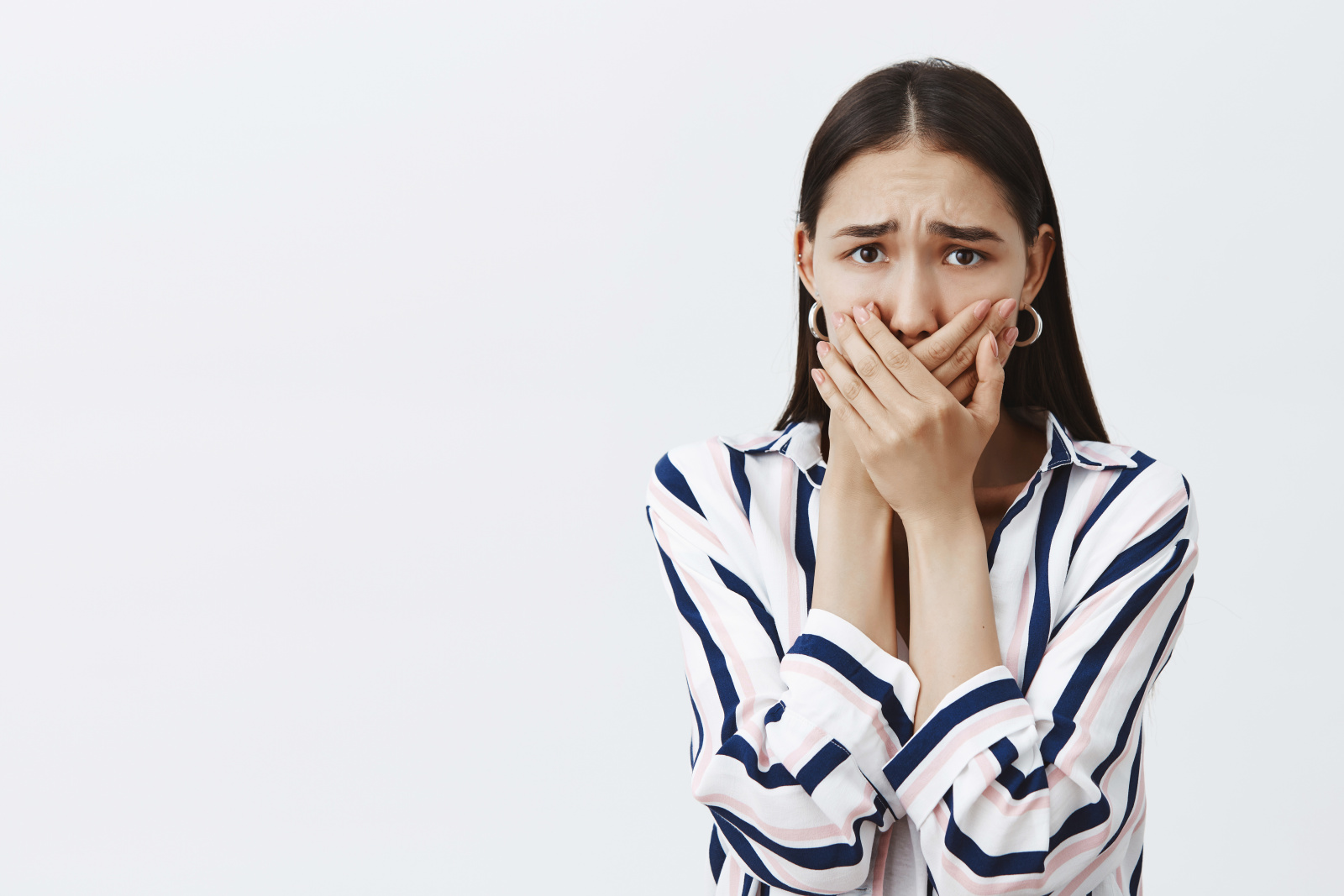 woman-being-harassed-afraid-tell-anyone-scared-anxious-woman-striped-blouse-trendy-earrings-covering-mouth-with-palms-scream-frowning-being-afraid-gray-wall.jpg